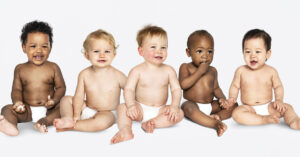 babies sitting in diapers on isolated white background